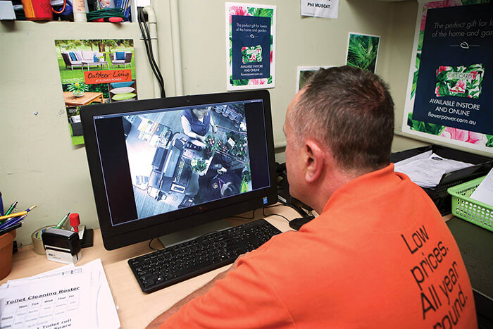 a man reviews video surveillance on a computer monitor