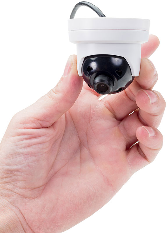 A hand holds the ME4 Discreet IR Dome security camera