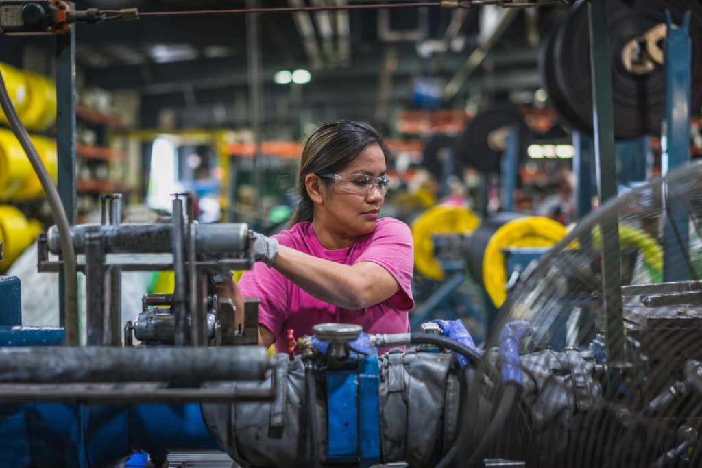  A WCCO Belting employee works with machinery at the company’s North Dakota plant. 