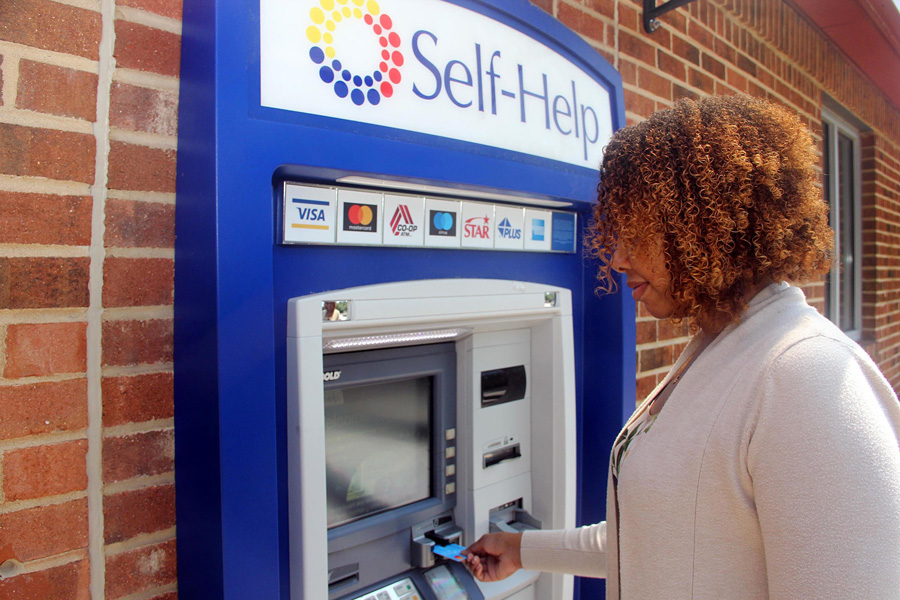 A woman uses a Self-Help Credit Union ATM