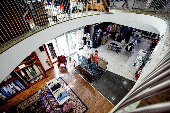 Overhead view of couple walking into a retail store
