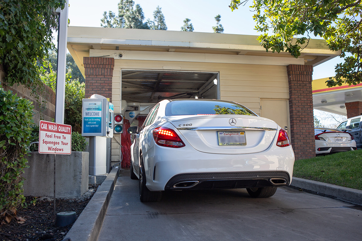 A white car entering the car wash at a Cox Family Stores location