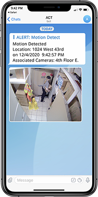 An image of a smartphone showing a real-time alert message that motion was detected at an entrance with a video snapshot.
