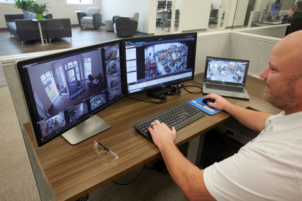 A Hamilton Safe employee reviews video using Command Enterprise Software.