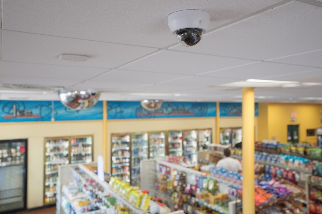 March Networks IP video camera shown in foreground of interior shot of Minit Stop convenience store.