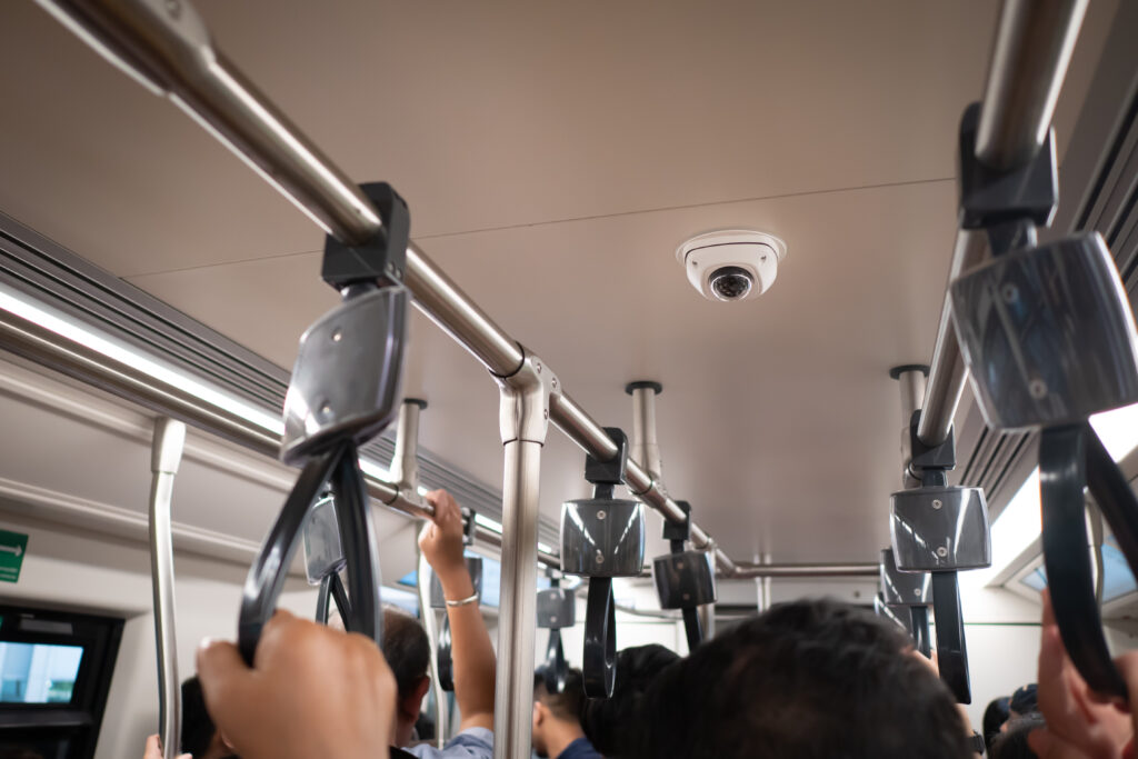 Photo of a surveillance camera in a transit vehicle with passengers aboard