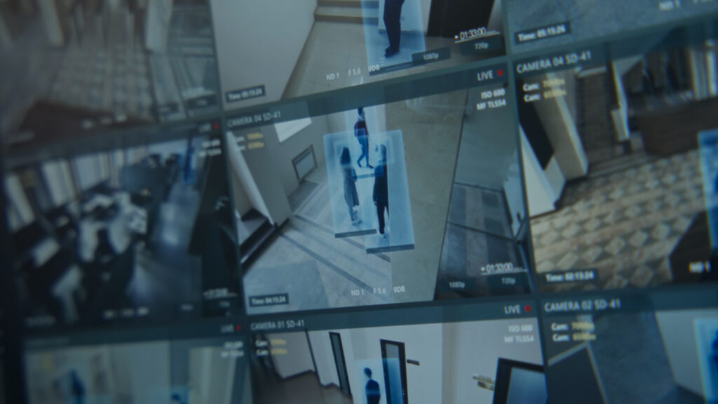 Close up shot of computer or digital tablet screen showing footage of surveillance cameras in coworking office with modern scanning system. CCTV cameras. High tech security. Concept of social safety.