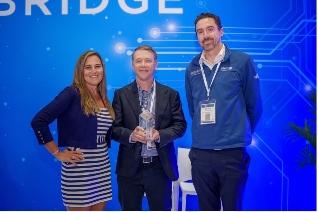 Marche Networks' Jeff Corrall, and Jeff Hanna pose with March Networks’ SIA award at ISC West in Las Vegas with Christine Bergeron, Chair of the SIA New Product Showcase (NPS) Awards Committee.