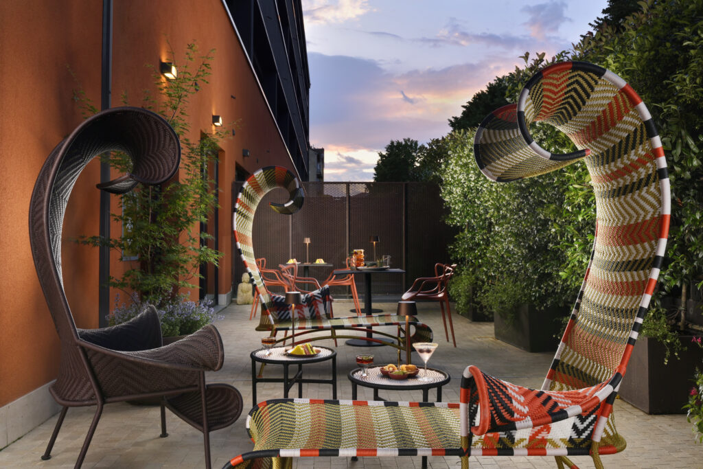 I tavolini all’aperto del Milan Suite Hotel offrono agli ospiti uno spazio moderno dove rilassarsi e socializzare.